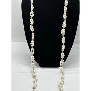 long necklace with bunched up puka shells In Three Tiers